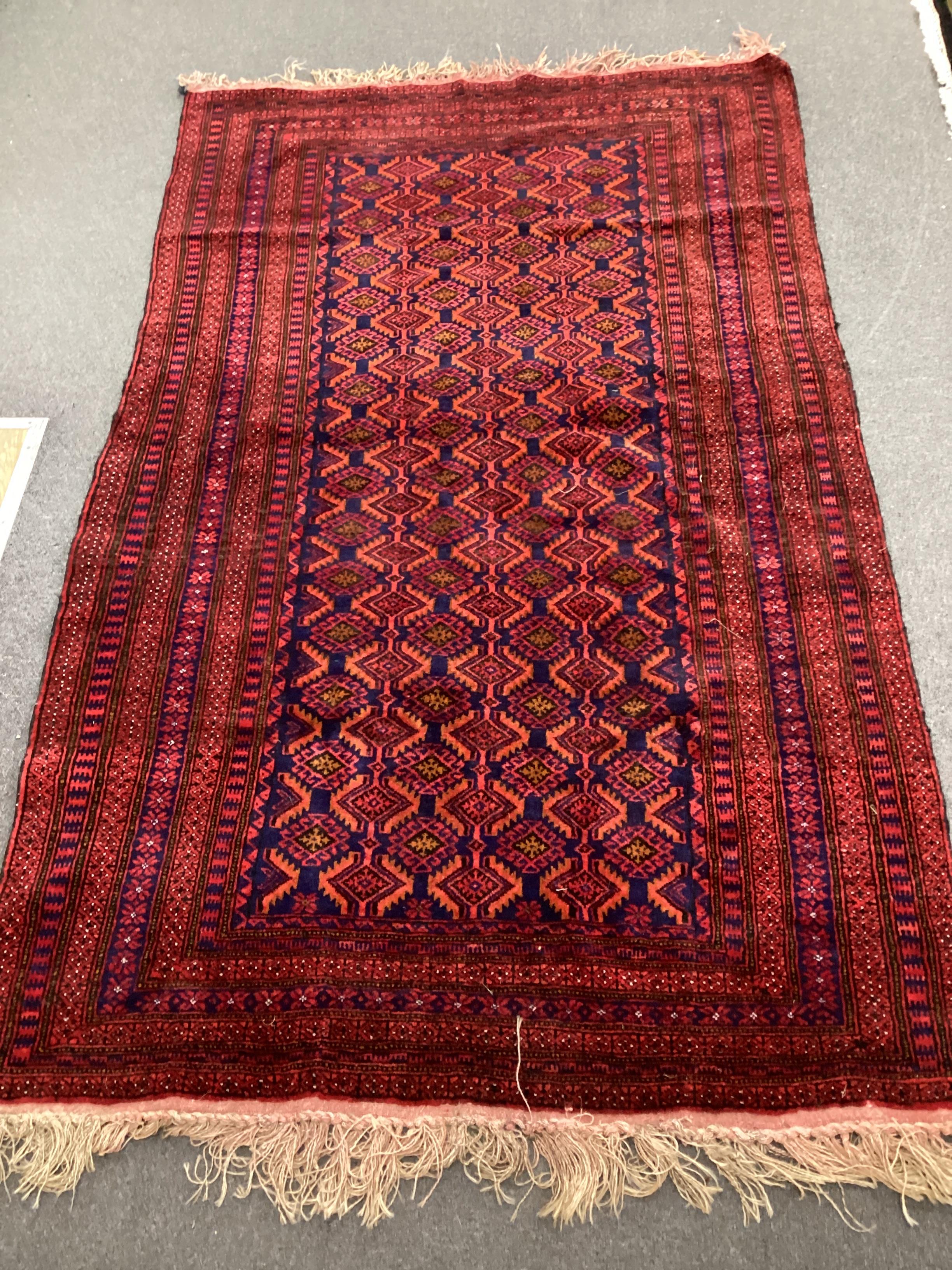 An Afghan blue ground rug, 216cm x 130cm